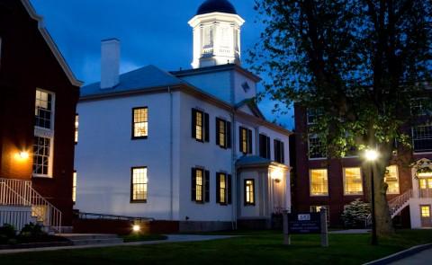 exterior of three buildings at night on the u n e portland campus