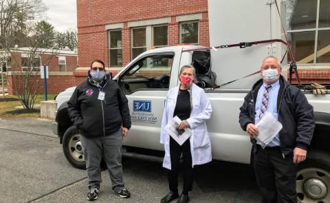 John Reid, left, facilities manager at the University of New England, stands with Karen Houseknecht, UNE’s associate provost for research, and Steven Boucouvalis, emergency operations coordinator with the Maine Center for Disease Control and Prevention. The ultra-cold freezer was delivered to a Maine CDC facility in a location that’s being kept secret for security reasons